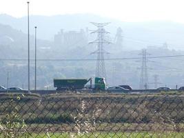 traffic on the highway and high voltage pylons in the background photo