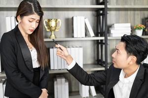 A male boss who pursues responsibility and a female businessman who receives power harassment. dissatisfied boss points on rude mistakes on report criticizing work scolding accusing  female employee photo