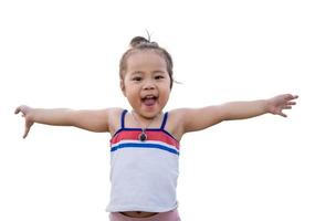 Happy Asian little girl having fun and raising hands up with her face to surprise and excited for something. Excited girl with raised arm having fun to play with isolated on white background. photo