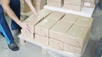 Factory worker on warehouse packing boxes for delivery photo