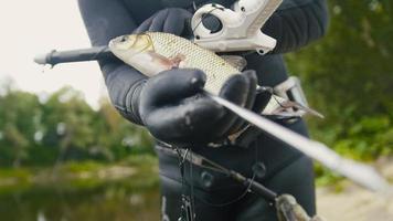 Freshwater Fish at spear of underwater fisherman after hunting in forest river photo