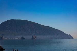 Mount Ayu Dag on the background of the Black Sea in the early morning. photo