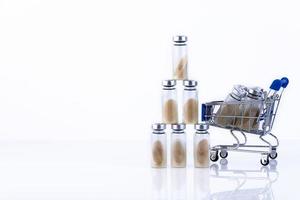 Vials, ampoules with dry probiotic, bifidobacteria inside, in the shopping cart. against the background of belrm. Copy space. photo