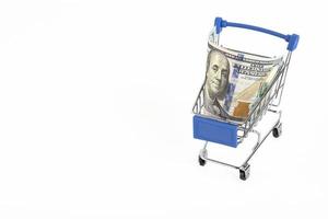 Shopping basket and US dollars on a white background. Copy space. photo