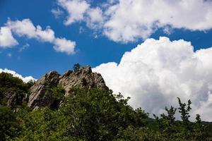 Red rock, cliff in the Gurzuf valley on the southern coast of the Crimea peninsula, located at an altitude of 430 meters above sea level. photo