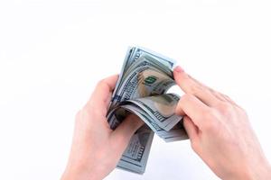 Woman's hands, count money, American one hundred dollar bills. Isolated on white. Copy space. photo