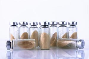 Vials, ampoules with dry probiotic, bifidobacteria, with probiotic powder inside on a white background. Copy space. photo