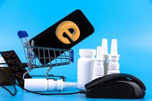 Blue banner with a shopping cart with pills and nasal spray. Online pharmacies. Copy space. photo