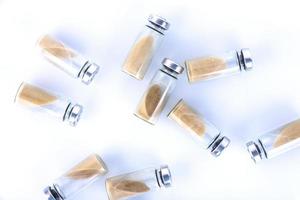Vials, ampoules with dry probiotic, bifidobacteria inside on a white background, scattered chaotically. Copy space. photo