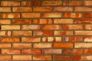 New brick wall from red bricks close-up texture. photo