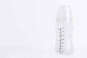 Baby feeding bottle with pacifier on a white background. Copy space. photo