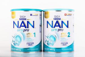 Moscow, Russia - July 8, 2021 - Milk formula in cans for feeding babies, NAN 1 OPTIPRO, NAN 2 OPTIPRO on a white background. photo