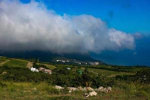 Mount Ayu Dag with clouds on the background of the Black Sea in the early morning. photo