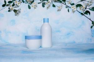 Collection of various containers for beauty hygiene on a blue and white background. photo