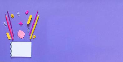 Back to school concept. School and office supplies on the office table. Violet background.Flat lay photo