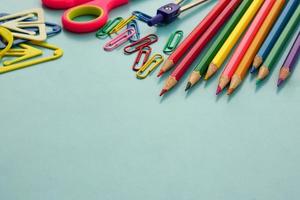 School supplies and office supplies on blue background. Learning, study, office equipment and presentation concept. photo