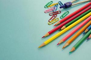 Top view of school supplies and office supplies on blue background. Learning, study, office equipment and presentation concept. photo