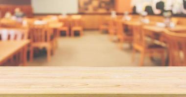 Restaurant interior with customer and wood table top over blur abstract background with bokeh light photo
