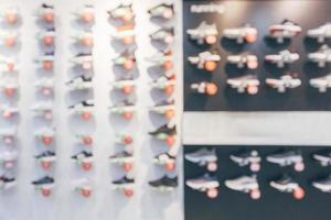 sneakers showcase on shelves in sport shoes store window display abstract blurred background photo