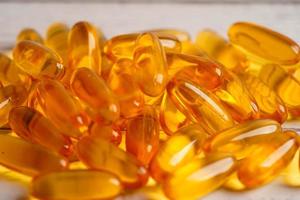 Fish oil or Cod liver oil gel in capsules with omega 3 vitamins, supplementary healthy food photo