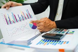 Businessman working and analysis with statistic graph in office. photo