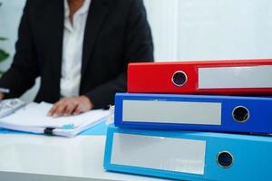 Stack of binder file folder on table in business modern office. photo