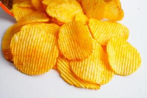 Potato chips in open bag, delicious BBQ seasoning spicy for crips, thin slice deep fried snack fast food. photo