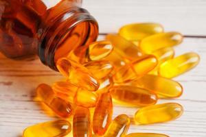 Fish oil or Cod liver oil gel in capsules with omega 3 vitamins, supplementary healthy food photo