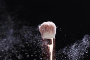 professional cosmetic brush with cosmetic product photo