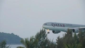 PHUKET, THAILAND NOVEMBER 29, 2016 - Qatar Airways Airbus 330 A7 AEA approaching before landing on the Phuket airport. View from the top floor of the hotel Centara Grand West Sands Resort Phuket video