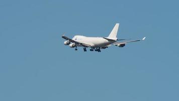 NOVOSIBIRSK, RUSSIAN FEDERATION JUNE 27, 2021 - White commercial cargo aircraft Boeing 747 of ASL airlines flies in blue sky, landing gear down and prepares for landing at the airport. video