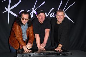 LOS ANGELES, NOV 20 - RUSH, Geddy Lee, Neil Peart, Alex Lifeson at the ceremony where RUSH is Inducted Into Guitar Center s RockWalk at Guitar Center on November 20, 2012 in Los Angeles, CA photo