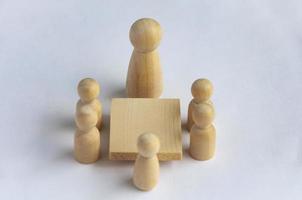 Wooden people figures having business meeting with customizable for text or ideas. photo