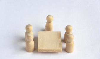 Wooden people figures having business meeting with customizable for text or ideas. photo