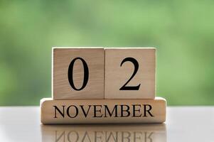 November 2 calendar date text on wooden blocks with copy space calendar concept photo