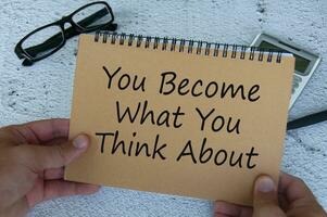You become what you think about text written on brown notepad. Motivational concept. photo