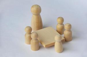 Wooden people figures having business meeting with customizable for text or ideas. photo