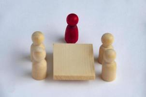 Wooden people figures having business meeting with customizable spare for text or ideas. photo