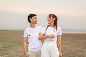 Happy young Asian couple in bride and groom t-shirt photo