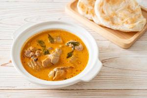 Chicken curry soup with roti photo