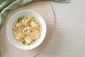 shrimp dumpling soup in white bowl photo