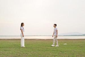 Happy young Asian couple in bride and groom t-shirt photo