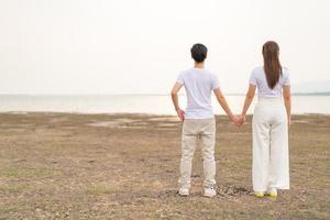 Happy young Asian couple in bride and groom t-shirt photo