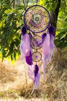 Handmade dream catcher with feathers threads and beads rope hanging photo