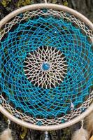 Handmade dream catcher with feathers threads and beads rope hanging photo
