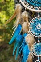 Handmade dream catcher with feathers threads and beads rope hanging photo