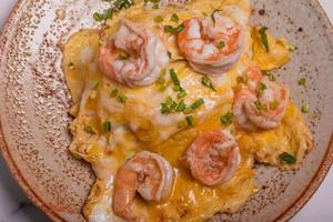Creamy omelette with shrimps on rice served fish sauce, Thai style photo