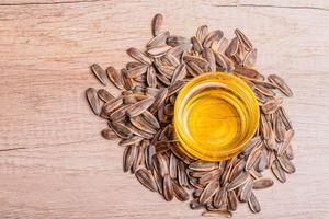 Sunflower oil in a glass cup and dried sunflower seeds photo