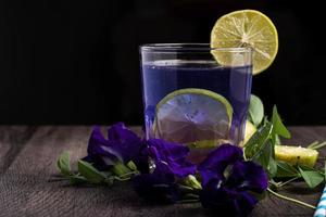 Butterfly pea and lemon juice, healthy drinks. Dark tones photo