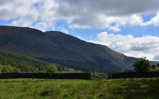 Scenic Grass Farmland and Fell in the Lakes District photo